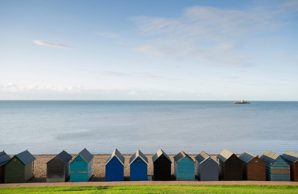 Row of colorful beach huts overlooking the sea at Herne Bay, near properties requiring an EPC certificate Herne Bay.
